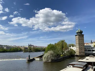 a view of a river with a tower in the water at Studio Balbin by Interhome in Prague