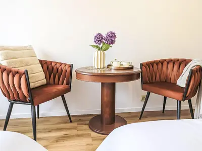 a table with two chairs and a table with flowers on it at Studio Balbin by Interhome in Prague