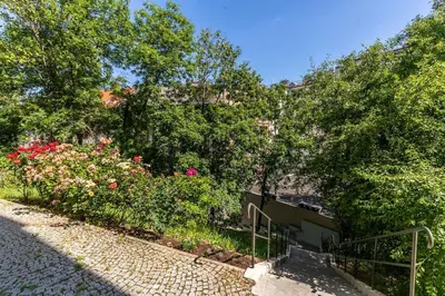 a garden with flowers and trees on a street at Bacpackers paradise in Prague City center in Prague