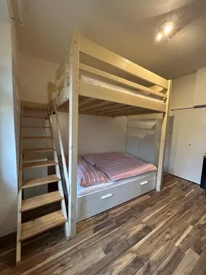 a bunk bed in a room with a staircase at Bacpackers paradise in Prague City center in Prague
