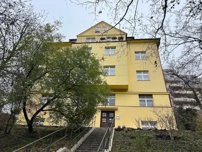 a yellow building with stairs in front of it at Bacpackers paradise in Prague City center in Prague
