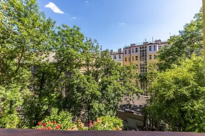 a large building with trees and flowers in front of it at Bacpackers paradise in Prague City center in Prague