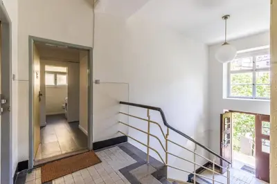 a hallway with a staircase and a window at Bacpackers paradise in Prague City center in Prague