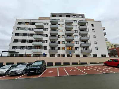 a large building with cars parked in a parking lot at Cozy Home 2 in Prague