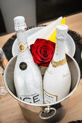 two bottles of champagne in a can with a rose at Victory Noble Estate in Prague