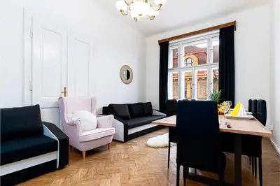 a living room with a couch and a table and chairs at Victory Noble Estate in Prague
