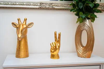 three gold vases sitting on a shelf in front of a mirror at Victory Noble Estate in Prague