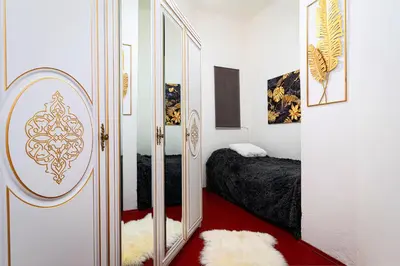 a bedroom with a mirror next to a bed at Victory Noble Estate in Prague