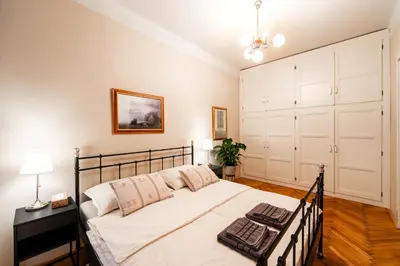 a bedroom with a bed with a black and white bedspread at Charming Apartment in Haštalská in Prague