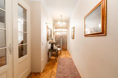 a hallway with a table and a picture on the wall at Charming Apartment in Haštalská in Prague