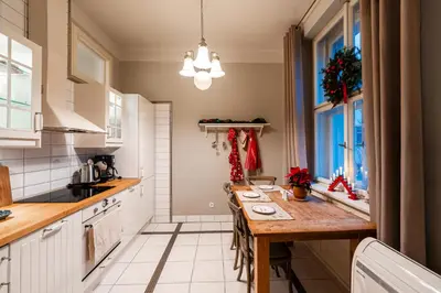 a kitchen with a wooden table in a room at Charming Apartment in Haštalská in Prague