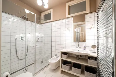a bathroom with a shower and a sink and a toilet at Charming Apartment in Haštalská in Prague