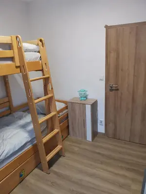 a room with two bunk beds and a door at Large Apartment with terrace and big garden in Prague
