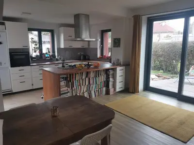 a kitchen with a table and a large window at Large Apartment with terrace and big garden in Prague