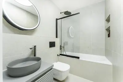 a bathroom with a sink and a toilet and a mirror at Rentero Urban Elegance Suite - Prague 7 in Prague