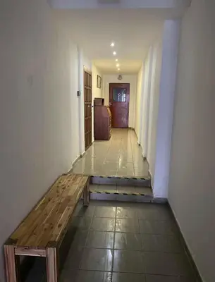 a hallway with a wooden bench in a room at Apartment Otakar in Nymburk