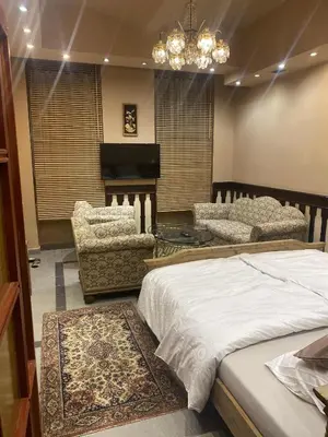 a bedroom with a bed and a table and a piano at Apartment Otakar in Nymburk