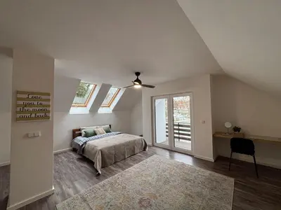 a bedroom with a bed and a ceiling fan at Retreat House Na návsi in Chotěšov