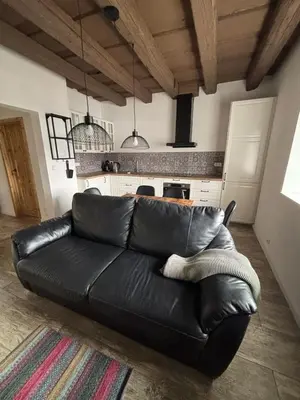 a black leather couch in a living room at Retreat House Na návsi in Chotěšov