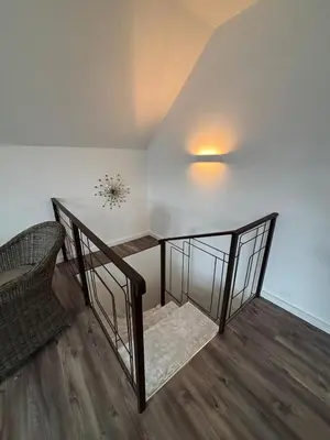 a staircase with a table and a chair in a room at Retreat House Na návsi in Chotěšov