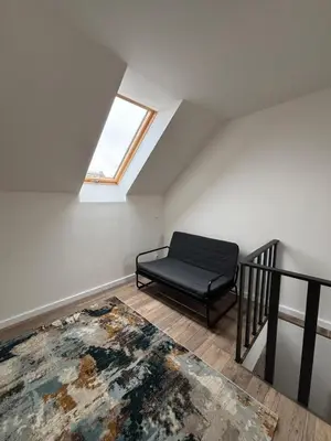 a room with a chair and a rug on the floor at Retreat House Na návsi in Chotěšov