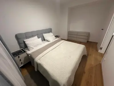 a bedroom with a large bed with white sheets at Cozy Apartments in Prague