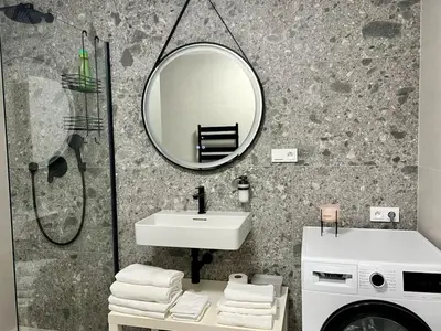 a bedroom with a bed with white sheets and a window at Cozy Apartments in Prague