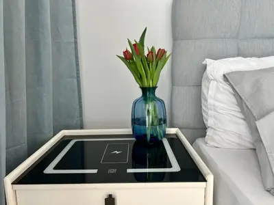 a bedroom with a large bed with blue curtains at Cozy Apartments in Prague