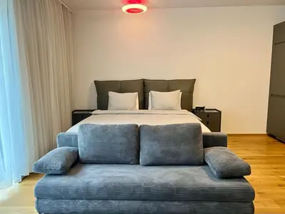 a living room with a couch and a tv and a table at Cozy Apartments in Prague