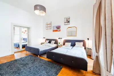 a living room with two beds and a couch at Huge 4 Rooms Charles Bridge Apartment in Prague
