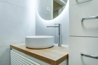 a bathroom with a sink and a mirror at Rentero Smíchov Riverside & Station Residence in Prague