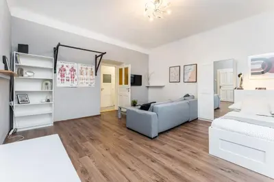 a living room with a bed and a couch at Rentero Smíchov Riverside & Station Residence in Prague