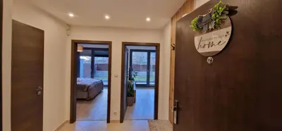 a hallway with a door with a sign on the wall at Garden Residence - Byt 412 in Prague