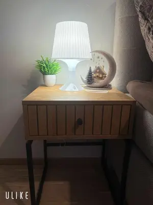 a nightstand with a lamp and a christmas decoration on it at Garden Residence - Byt 412 in Prague