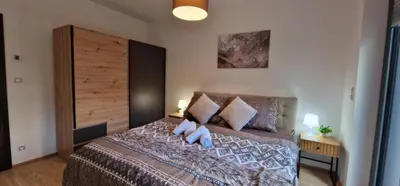 a bedroom with a large bed with two pillows at Garden Residence - Byt 412 in Prague