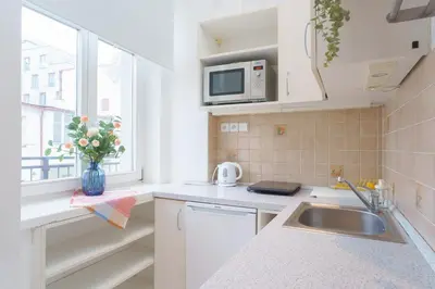 a kitchen with a sink and a microwave at Quiet Apartment Near River and City Center in Prague