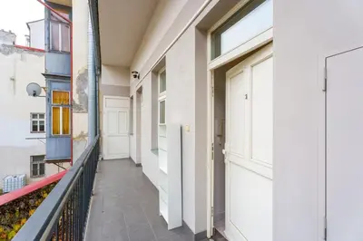 a corridor of a building with a balcony at Quiet Apartment Near River and City Center in Prague