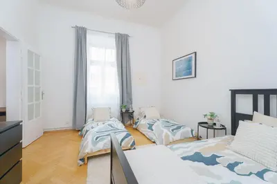 a living room with two beds and a couch at Quiet Apartment Near River and City Center in Prague