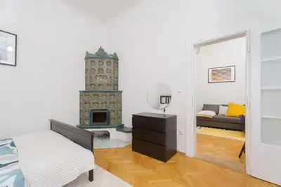 a living room with a bed and a fireplace at Quiet Apartment Near River and City Center in Prague