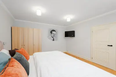 a bedroom with a bed and a tv on the wall at Bohemia Boutique Hotel Prague in Prague