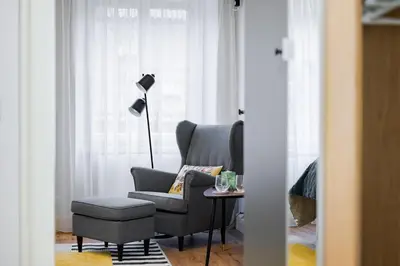 a living room with a chair and a lamp at Bohemia Boutique Hotel Prague in Prague