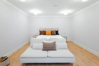 a white couch in a room with a bed at Bohemia Boutique Hotel Prague in Prague