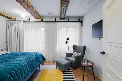 a bedroom with a bed and a chair and a window at Bohemia Boutique Hotel Prague in Prague