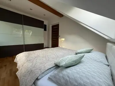 a bedroom with a bed with two pillows on it at Apartmán Břevnov in Prague