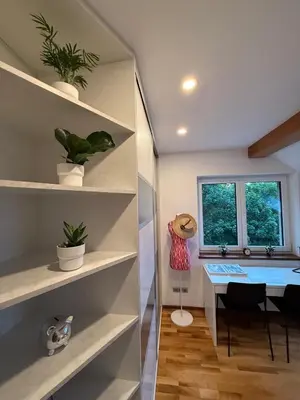 a home office with a desk and a table at Apartmán Břevnov in Prague