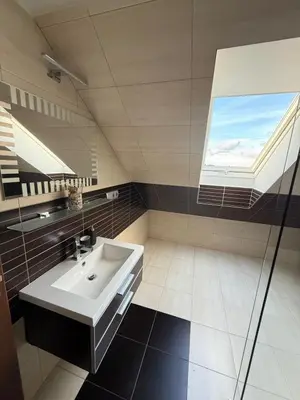 a bathroom with a sink and a window at Apartmán Břevnov in Prague