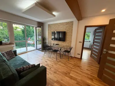 a living room with a couch and a table with chairs at Apartmán Břevnov in Prague