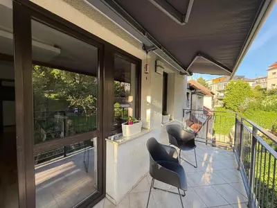 a patio with two chairs and a balcony at Apartmán Břevnov in Prague