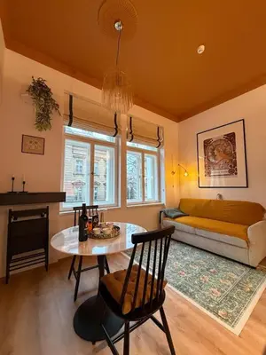 a living room with a table and a couch at Alphonse Mucha Loft Apartments, Prague 2 in Prague