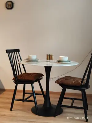 a table and two chairs with a white table and two cups at Alphonse Mucha Loft Apartments, Prague 2 in Prague